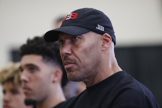 LaVar Ball, center, father of Los Angeles Lakers draft pick Lonzo Ball, listens to his son during a news conference, Friday, June 23, 2017, in El Segundo, Calif. (AP Photo/Jae C. Hong)