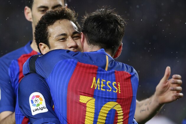 FC Barcelona's Lionel Messi, front, embraces his teammate Neymar after scoring during the Spanish La Liga soccer match between FC Barcelona and Sevilla at the Camp Nou stadium in Barcelona, Spain, Wednesday, April 5, 2017. (AP Photo/Manu Fernandez)