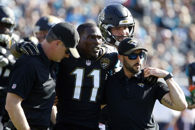 Jacksonville Jaguars wide receiver Marqise Lee (11) is helped off the field after he was injured during the first half of an NFL football game against the Houston Texans, Sunday, Dec. 17, 2017, in Jacksonville, Fla. (AP Photo/Stephen B. Morton)