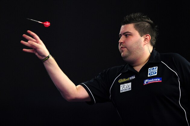 LONDON, ENGLAND - JANUARY 01:  Michael Smith of England throws during his quarter final match against Raymond van Barneveld of the Netherlands during Day Thirteen of the 2016 William Hill PDC World Darts Championships at Alexandra Palace on January 1, 2016 in London, England.  (Photo by Dan Mullan/Getty Images)