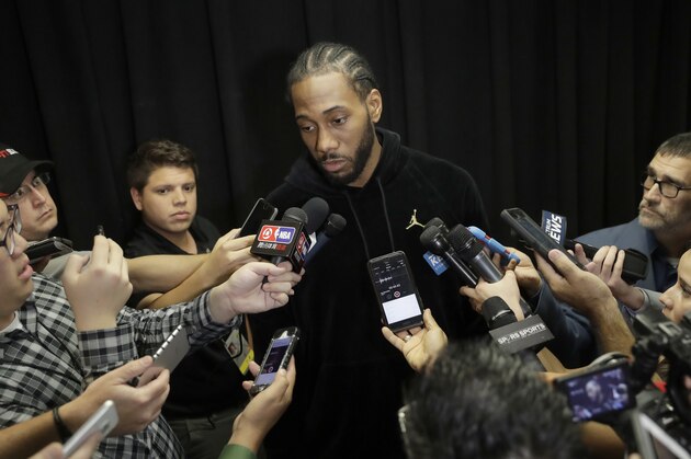 San Antonio Spurs forward Kawhi Leonard, who has not played this season due to an injury, talks with the media before an NBA basketball game against the Detroit Pistons, Monday, Dec. 4, 2017, in San Antonio. Leonard is expected to return to play soon. (AP Photo/Eric Gay)