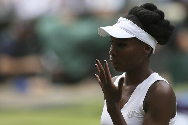 Venus Williams of the United States gestures for a towel to wipe her face as she plays Britain's Johanna Konta during their Women's Singles semifinal match on day nine at the Wimbledon Tennis Championships in London Thursday, July 13, 2017. (AP Photo/Tim Ireland)