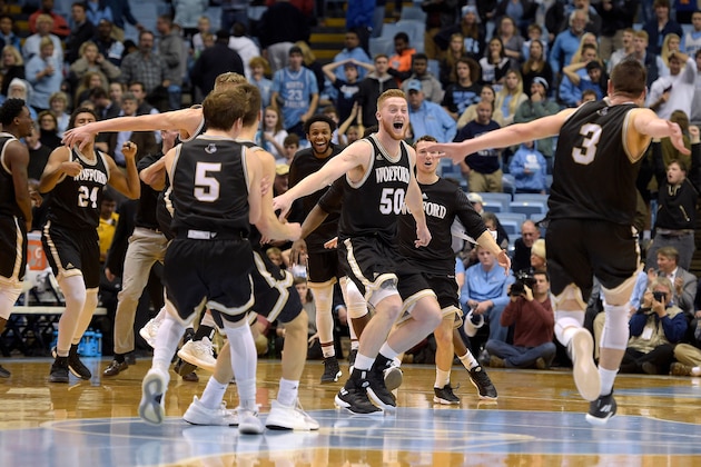 CHAPEL HILL, NC - DECEMBER 20: Matthew Pegram #50 and Fletcher Magee #3 of the Wofford Terriers celebrate with teammates following their win against the North Carolina Tar Heels at Dean Smith Center on December 20, 2017 in Chapel Hill, North Carolina. Wofford won 79-75. (Photo by Lance King/Getty Images)