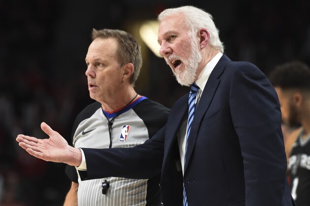 San Antonio Spurs coach Gregg Popovich talks to referee Bill Spooner during the second half of the team's NBA basketball game against the Portland Trail Blazers in Portland, Ore., Wednesday, Dec. 20, 2017. The Spurs won 93-91. (AP Photo/Steve Dykes)