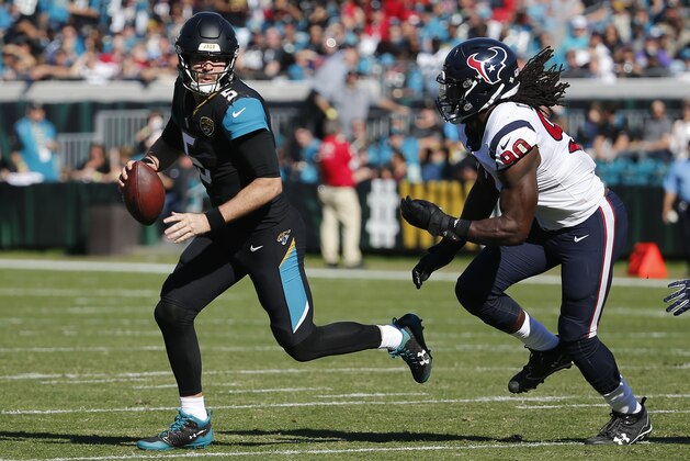 FILE - In this Dec. 17, 2017, file photo, Jacksonville Jaguars quarterback Blake Bortles, left, looks for a receiver as he is pressured by Houston Texans defensive end Jadeveon Clowney (90) during the first half of an NFL football game, in Jacksonville, Fla. Clearly frustrated following a 45-7 loss at Jacksonville on Sunday, Clowney called Bortles trash after the game.“If how we’re playing and how I’m playing is trash, then I’m fine with being trash,” Bortles said Wednesday, Dec. 20.(AP Photo/Stephen B. Morton, File)