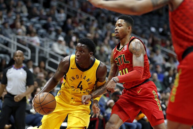 Atlanta Hawks' Kent Bazemore, right, defends against Indiana Pacers' Victor Oladipo in the third quarter of an NBA basketball game in Atlanta, Wednesday, Dec. 20, 2017. Indiana won 105-95. (AP Photo/David Goldman)