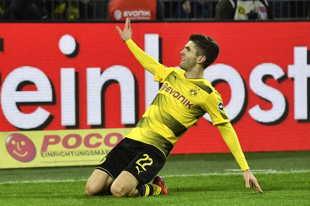Dortmund's Christian Pulisic celebrates after he scored his side's second goal during the German Bundesliga soccer match between Borussia Dortmund and TSG Hoffenheim in Dortmund, Germany, Saturday, Dec. 16, 2017. Dortmund defeated Hoffenheim with 2-1. (AP Photo/Martin Meissner)