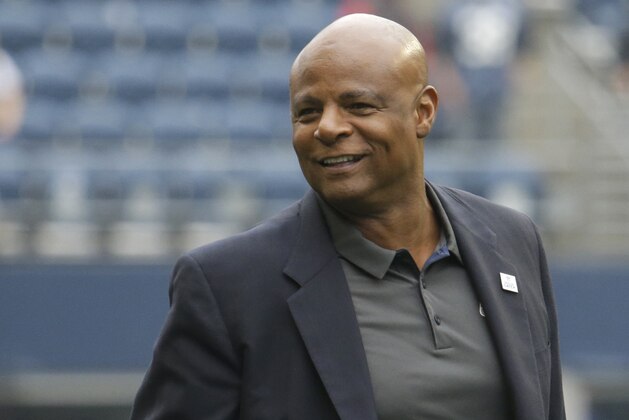 NFL Hall of Fame quarterback Warren Moon stands on the field before an NFL football game between the Houston Texans and the Seattle Seahawks, Sunday, Oct. 29, 2017, in Seattle. (AP Photo/Elaine Thompson)