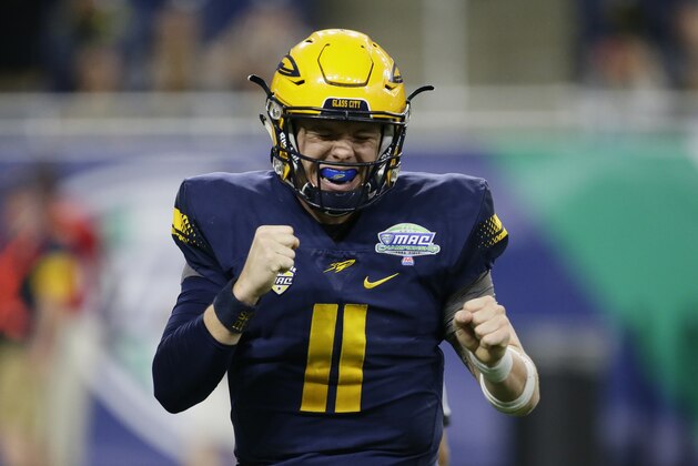 DETROIT, MI - DECEMBER 02: Quarterback Logan Woodside #11 of the Toledo Rockets celebrates a touchdown against Akron during the first half at Ford Field on December 2, 2017 in Detroit, Michigan. (Photo by Duane Burleson/Getty Images)