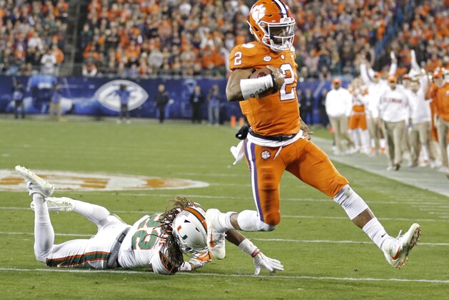 Clemson's Kelly Bryant (2) runs past Miami's Sheldrick Redwine (22) for a touchdown during the first half of the Atlantic Coast Conference championship NCAA college football game in Charlotte, N.C., Saturday, Dec. 2, 2017. (AP Photo/Bob Leverone)
