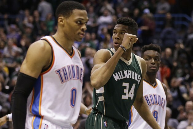 Milwaukee Bucks' Giannis Antetokounmpo (34) pumps his fist as Oklahoma City Thunder's Russell Westbrook (0) and Jerami Grant (9) leave the floor after an NBA basketball game Monday, Jan. 2, 2017, in Milwaukee. The Bucks won 98-94. Antetokounmpo had 26 points. (AP Photo/Jeffrey Phelps)