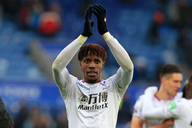 Crystal Palace's Ivorian striker Wilfried Zaha celebrates on the pitch after the English Premier League football match between Leicester City and Crystal Palace at King Power Stadium in Leicester, central England on December 16, 2017.
Crystal Palace won the game 3-0. / AFP PHOTO / Lindsey PARNABY / RESTRICTED TO EDITORIAL USE. No use with unauthorized audio, video, data, fixture lists, club/league logos or 'live' services. Online in-match use limited to 75 images, no video emulation. No use in betting, games or single club/league/player publications.  /         (Photo credit should read LINDSEY PARNABY/AFP/Getty Images)