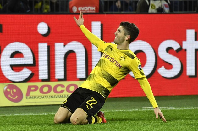 Dortmund's Christian Pulisic celebrates after he scored his side's second goal during the German Bundesliga soccer match between Borussia Dortmund and TSG Hoffenheim in Dortmund, Germany, Saturday, Dec. 16, 2017. Dortmund defeated Hoffenheim with 2-1. (AP Photo/Martin Meissner)