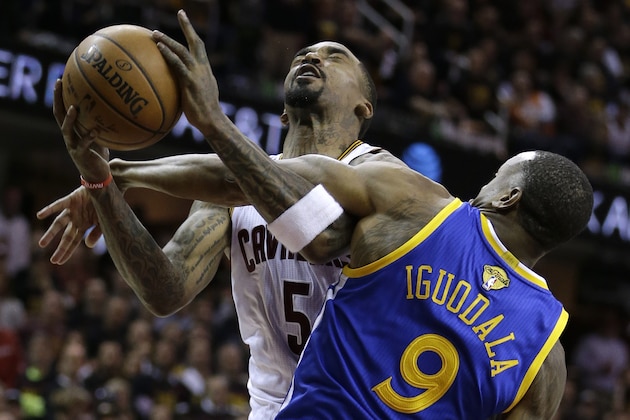 Golden State Warriors forward Andre Iguodala (9) fouls Cleveland Cavaliers guard J.R. Smith (5) during the second half of Game 3 of basketball's NBA Finals in Cleveland, Wednesday, June 7, 2017. (AP Photo/Tony Dejak)