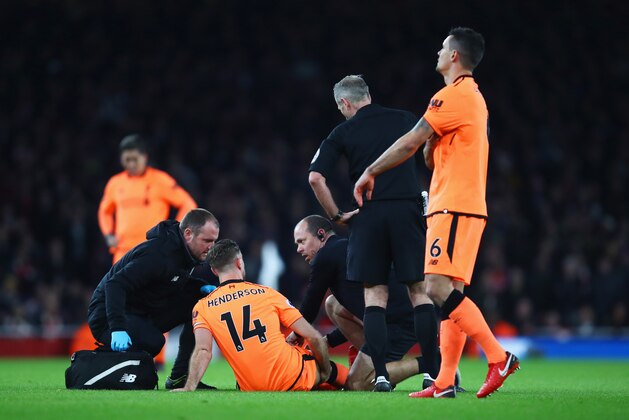 LONDON, ENGLAND - DECEMBER 22:  An injured Jordan Henderson of Liverpool (14) is given assistance during the Premier League match between Arsenal and Liverpool at Emirates Stadium on December 22, 2017 in London, England.  (Photo by Julian Finney/Getty Images)