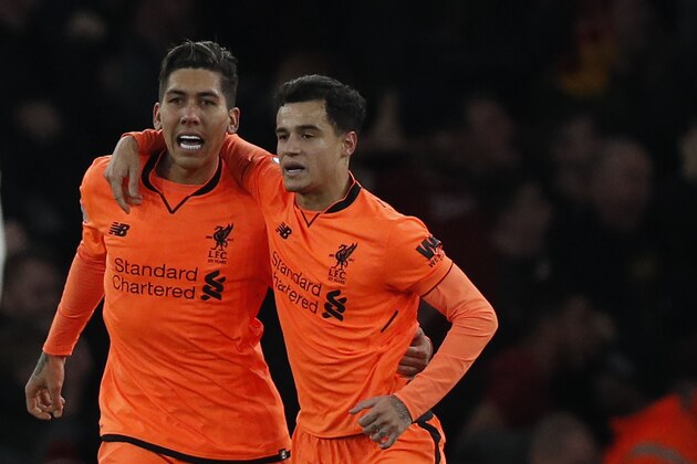 Liverpool's Brazilian midfielder Roberto Firmino (L) celebrates scoring  the team's third goal with Liverpool's Brazilian midfielder Philippe Coutinho during the English Premier League football match between Arsenal and Liverpool at the Emirates Stadium in London on December 22, 2017.  / AFP PHOTO / Adrian DENNIS / RESTRICTED TO EDITORIAL USE. No use with unauthorized audio, video, data, fixture lists, club/league logos or 'live' services. Online in-match use limited to 75 images, no video emulation. No use in betting, games or single club/league/player publications.  /         (Photo credit should read ADRIAN DENNIS/AFP/Getty Images)