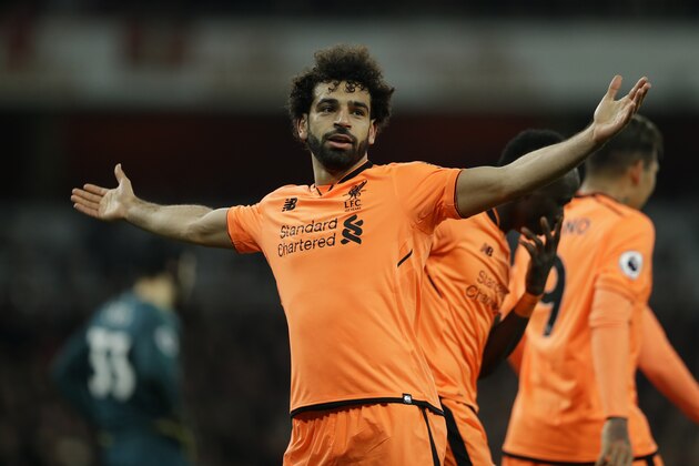 Liverpool's Mohamed Salah celebrates after he scores his sides 2nd goal of the gameduring their English Premier League soccer match between Arsenal and Liverpool at the Emirates stadium London, Friday, Dec. 22, 2017. (AP Photo/Alastair Grant)
