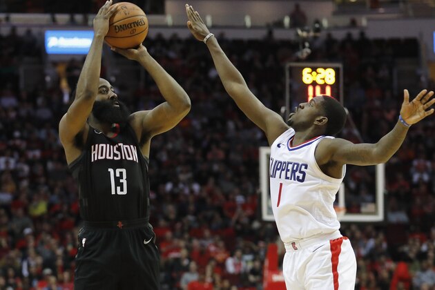 HOUSTON, TX - DECEMBER 22:  James Harden #13 of the Houston Rockets takes a three point shot defended by Jawun Evans #1 of the LA Clippers in the first half at Toyota Center on December 22, 2017 in Houston, Texas.  NOTE TO USER: User expressly acknowledges and agrees that, by downloading and or using this Photograph, user is consenting to the terms and conditions of the Getty Images License Agreement.  (Photo by Tim Warner/Getty Images)