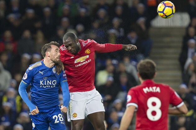 Leicester City's Austrian defender Christian Fuchs (L) heads the ball clear under pressure from Manchester United's Belgian striker Romelu Lukaku during the English Premier League football match between Leicester City and Manchester United at King Power Stadium in Leicester, central England on December 23, 2017. / AFP PHOTO / Roland HARRISON / RESTRICTED TO EDITORIAL USE. No use with unauthorized audio, video, data, fixture lists, club/league logos or 'live' services. Online in-match use limited to 75 images, no video emulation. No use in betting, games or single club/league/player publications.  /         (Photo credit should read ROLAND HARRISON/AFP/Getty Images)