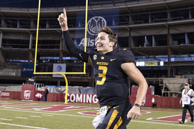 FAYETTEVILLE, AR - NOVEMBER 24:  Drew Lock #3 of the Missouri Tigers runs around the field in celebration after a game against the Arkansas Razorbacks at Razorback Stadium on November 24, 2017 in Fayetteville, Arkansas.  The Tigers defeated the Razorbacks 48-45.  (Photo by Wesley Hitt/Getty Images)