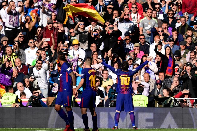 Barcelona's Argentinian forward Lionel Messi (R) celebrates after scoring during the Spanish League 'Clasico' football match Real Madrid CF vs FC Barcelona at the Santiago Bernabeu stadium in Madrid on December 23, 2017.  / AFP PHOTO / JAVIER SORIANO        (Photo credit should read JAVIER SORIANO/AFP/Getty Images)