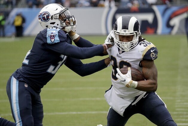 Los Angeles Rams running back Todd Gurley (30) tries to push away from Tennessee Titans free safety Kevin Byard, left, in the second half of an NFL football game Sunday, Dec. 24, 2017, in Nashville, Tenn. (AP Photo/James Kenney)