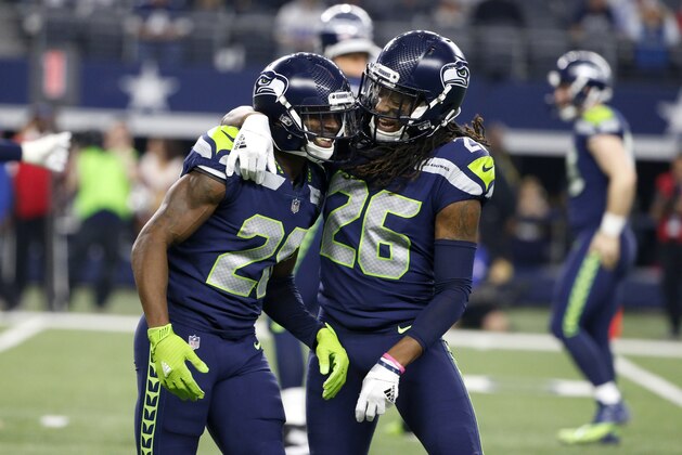 Seattle Seahawks' Justin Coleman (28) and Shaquill Griffin (26) celebrate a touchdown scored by Coleman on a Dallas Cowboys' Dak Prescott interception in the second half of an NFL football game, Sunday, Dec. 24, 2017, in Arlington, Texas. (AP Photo/Michael Ainsworth)