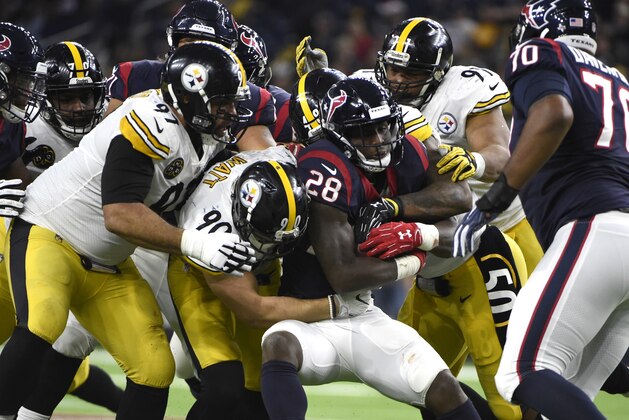 Houston Texans running back Alfred Blue (28) is wrapped up by Pittsburgh Steelers' T.J. Watt (90), Cameron Heyward (97), Bud Dupree, Stephon Tuitt during the second half of an NFL football game Monday, Dec. 25, 2017, in Houston. (AP Photo/Eric Christian Smith)