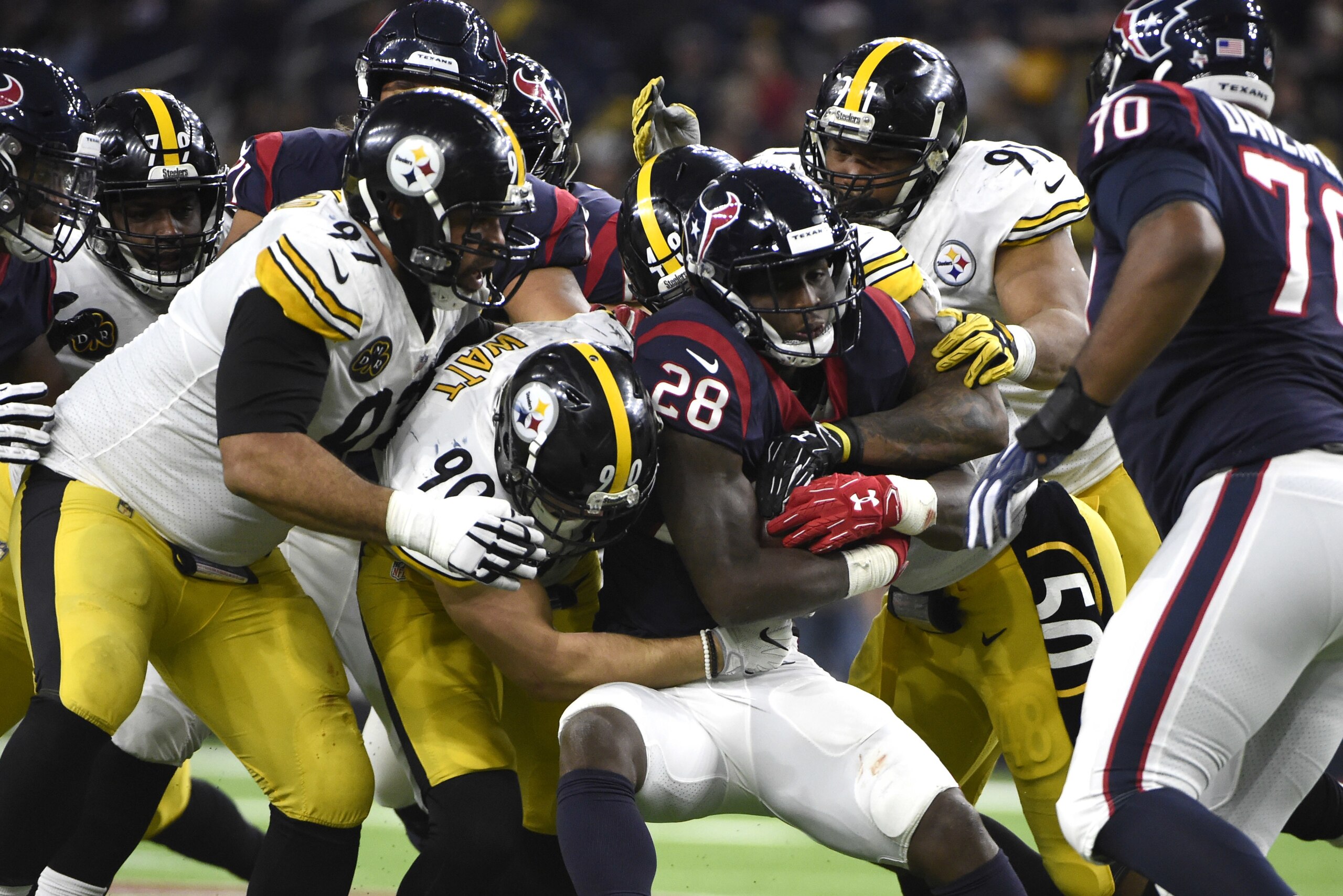 Houston Texans running back Alfred Blue (28) is wrapped up by Pittsburgh Steelers' T.J. Watt (90), Cameron Heyward (97), Bud Dupree, Stephon Tuitt during the second half of an NFL football game Monday, Dec. 25, 2017, in Houston. (AP Photo/Eric Christian Smith)