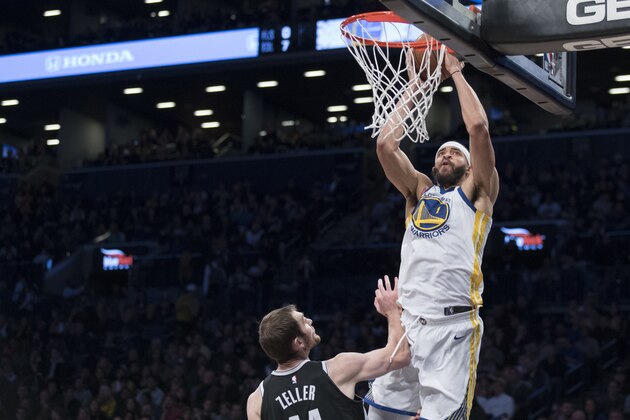 Golden State Warriors center JaVale McGee (1) goes to the basket past Brooklyn Nets center Tyler Zeller during the first half of an NBA basketball game, Sunday, Nov. 19, 2017, in New York. (AP Photo/Mary Altaffer)