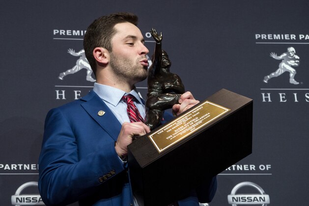 FILE - In this Dec. 9, 2017, file photo, Oklahoma quarterback Baker Mayfield, winner of the Heisman Trophy, poses with the trophy in New York. The Rose Bowl's marquee matchup of Georgia safety Roquan Smith, the Butkus Award winner, against Oklahoma's Heisman-winning quarterback Baker Mayfield, is attractive. (AP Photo/Craig Ruttle, File)
