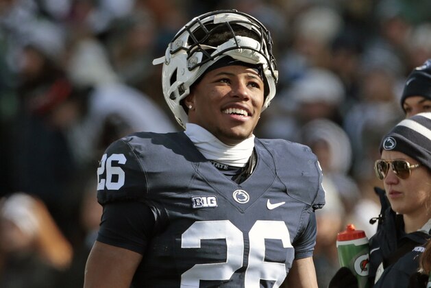 FILE - In this Nov. 11, 2017, file photo, Penn State's Saquon Barkley (26) is all smiles before the team takes on Rutgers in an NCAA college football game in State College, Pa. Penn State’s Saquon Barkley is the offensive player of the year for the second straight season and Iowa linebacker Josey Jewell is defensive player of the year on The Associated Press All-Big Ten Conference team, announced Wednesday, Dec. 6, 2017. (AP Photo/Chris Knight, File)