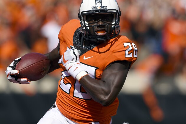 FILE - In this Sept. 23, 2017, file photo, Oklahoma State wide receiver James Washington (28) runs with the ball during an NCAA college football game against TCU in Stillwater, Okla. Oklahoma State faces Texas on Saturday. (AP Photo/Brody Schmidt, File)