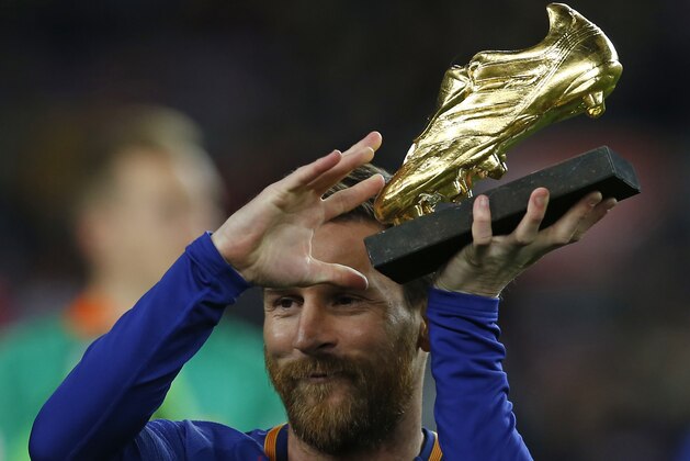 FC Barcelona's Lionel Messi holds up the Golden Shoe award, as the last season's leading goalscorer in league matches from the top division of every European national league, prior of the Spanish La Liga soccer match between FC Barcelona and Deportivo Coruna at the Camp Nou stadium in Barcelona, Spain, Sunday, Dec. 17, 2017. (AP Photo/Manu Fernandez)