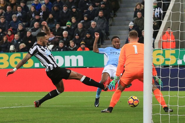 Manchester City's English midfielder Raheem Sterling (C) scores the opening goal during the English Premier League football match between Newcastle United and Manchester City at St James' Park in Newcastle-upon-Tyne, north east England on December 27, 2017. / AFP PHOTO / Lindsey PARNABY / RESTRICTED TO EDITORIAL USE. No use with unauthorized audio, video, data, fixture lists, club/league logos or 'live' services. Online in-match use limited to 75 images, no video emulation. No use in betting, games or single club/league/player publications.  /         (Photo credit should read LINDSEY PARNABY/AFP/Getty Images)