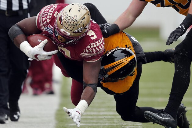 Florida State running back Jacques Patrick (9) is tackled by Southern Mississippi defensive back Tarvarius Moore, in the first half of the Independence Bowl NCAA college football game in Shreveport, La., Wednesday, Dec. 27, 2017. (AP Photo/Gerald Herbert)
