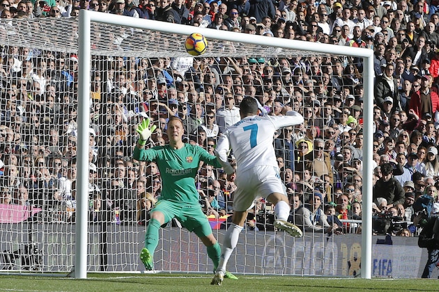 Real Madrid's Cristiano Ronaldo puts the ball in the back of the net but the goal was disallowed during the Spanish La Liga soccer match between Real Madrid and Barcelona at the Santiago Bernabeu stadium in Madrid, Spain, Saturday, Dec. 23, 2017. (AP Photo/Paul White)