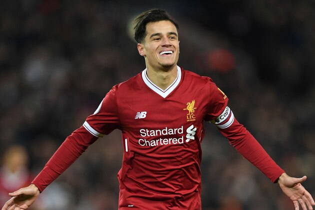 Liverpool's Brazilian midfielder Philippe Coutinho celebrates scoring the opening goal of the English Premier League football match between Liverpool and Swansea City at Anfield in Liverpool, north west England on December 26, 2017. / AFP PHOTO / Paul ELLIS / RESTRICTED TO EDITORIAL USE. No use with unauthorized audio, video, data, fixture lists, club/league logos or 'live' services. Online in-match use limited to 75 images, no video emulation. No use in betting, games or single club/league/player publications.  /         (Photo credit should read PAUL ELLIS/AFP/Getty Images)