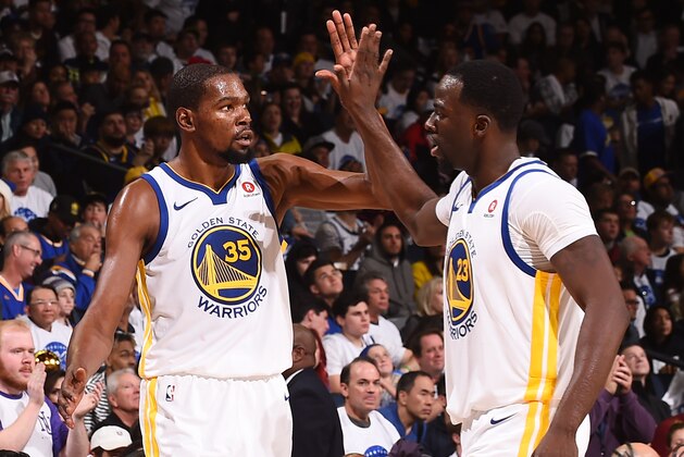 OAKLAND, CA - DECEMBER 25:  Kevin Durant #35 of the Golden State Warriors and Draymond Green #23 of the Golden State Warriors high five during the game against the Cleveland Cavaliers on December 25, 2017 at ORACLE Arena in Oakland, California. NOTE TO USER: User expressly acknowledges and agrees that, by downloading and or using this photograph, user is consenting to the terms and conditions of Getty Images License Agreement. Mandatory Copyright Notice: Copyright 2017 NBAE (Photo by Noah Graham/NBAE via Getty Images)