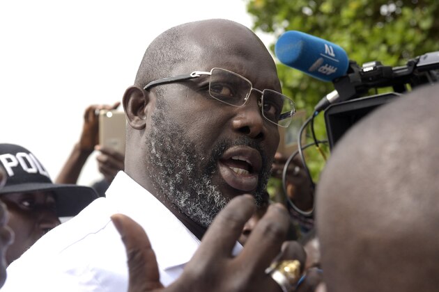 Football icon and candidate for the president election for the Coalition for Democratic Change (CDC) party, George Weah speaks to journalists after casting his ballot for the second round of presidential elections on December 26, 2017 at a polling station in Monrovia. 
Liberians go to the polls in a run-off presidential election on December 26 between Vice President Joseph Boakai and footballing icon George Weah, a vote that will mark the country's first democratic transition since 1944. / AFP PHOTO / SEYLLOU        (Photo credit should read SEYLLOU/AFP/Getty Images)