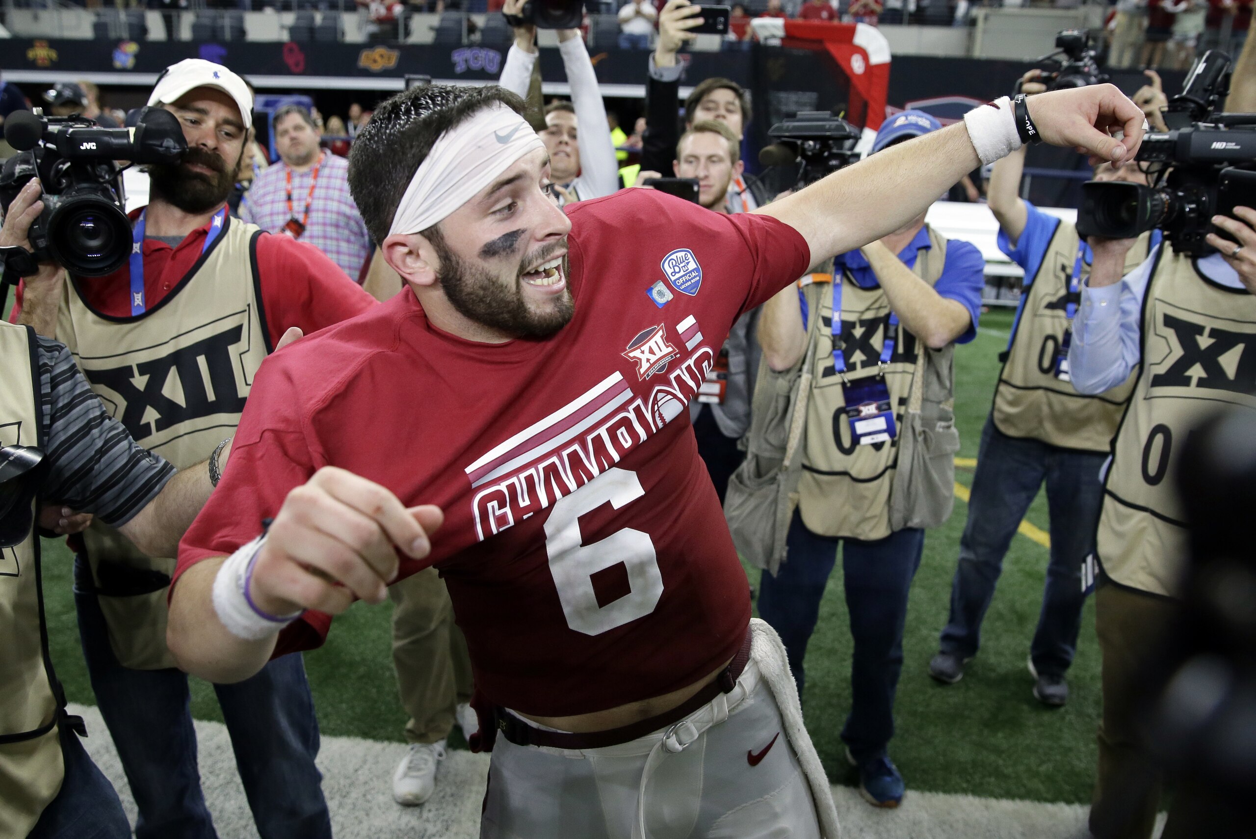 Oklahoma quarterback Baker Mayfield celebrates as he puts on his championship t-shirt after their Big 12 Conference championship NCAA college football game against TCU on Saturday, Dec. 2, 2017, in Arlington, Texas. (AP Photo/Tony Gutierrez) Oklahoma quarterback Baker Mayfield celebrates as he puts on his championship t-shirt after their Big 12 Conference championship NCAA college football game against TCU on Saturday, Dec. 2, 2017, in Arlington, Texas. (AP Photo/Tony Gutierrez)