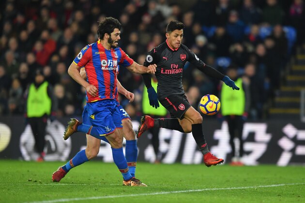 Arsenal's Chilean striker Alexis Sanchez (R) controls the ball on his way to score the their third goal during the English Premier League football match between Crystal Palace and Arsenal at Selhurst Park in south London on December 28, 2017. / AFP PHOTO / Ben STANSALL / RESTRICTED TO EDITORIAL USE. No use with unauthorized audio, video, data, fixture lists, club/league logos or 'live' services. Online in-match use limited to 75 images, no video emulation. No use in betting, games or single club/league/player publications.  /         (Photo credit should read BEN STANSALL/AFP/Getty Images)