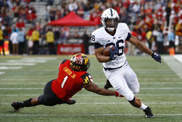 Penn State running back Saquon Barkley, right, rushes past Maryland linebacker Jermaine Carter Jr. in the first half of an NCAA college football game in College Park, Md., Saturday, Nov. 25, 2017. (AP Photo/Patrick Semansky)