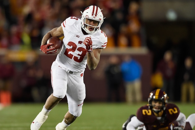 MINNEAPOLIS, MN - NOVEMBER 25: Jonathan Taylor #23 of the Wisconsin Badgers carries the ball for a touchdown after avoiding a tackle by Jacob Huff #2 of the Minnesota Golden Gophers during the fourth quarter of the game on November 25, 2017 at TCF Bank Stadium in Minneapolis, Minnesota. The Badgers defeated the Golden Gophers 31-0. (Photo by Hannah Foslien/Getty Images)