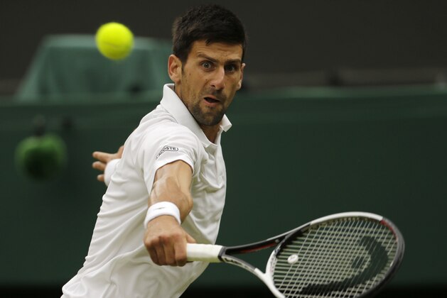 Serbia's Novak Djokovic returns to Adrian Mannarino of France during their Men's Singles Match on day eight at the Wimbledon Tennis Championships in London Tuesday, July 11, 2017. (AP Photo/Alastair Grant)