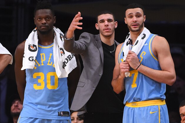 LOS ANGELES, CA - DECEMBER 27:  Julius Randle #30, Lonzo Ball #2 and Larry Nance Jr. #7 of the Los Angeles Lakers look on from the bench in the fourth quarter of the game at Staples Center on December 27, 2017 in Los Angeles, California.  (Photo by Jayne Kamin-Oncea/Getty Images). NOTE TO USER: User expressly acknowledges and agrees that, by downloading and or using this photograph, User is consenting to the terms and conditions of the Getty Images License Agreement.