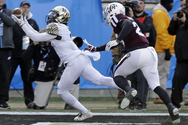 Wake Forest's Tabari Hines (1) catches a touchdown pass as Texas A&M's Deshawn Capers-Smith (26) defends during the first half of the Belk Bowl NCAA college football game in Charlotte, N.C., Friday, Dec. 29, 2017. (AP Photo/Chuck Burton)