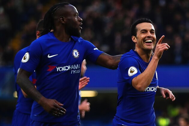 LONDON, ENGLAND - DECEMBER 30: Pedro of Chelsea celebrates scoring his side's third goal with team-mate Victor Moses during the Premier League match between Chelsea and Stoke City at Stamford Bridge on December 30, 2017 in London, England. (Photo by Chris Brunskill Ltd/Getty Images)