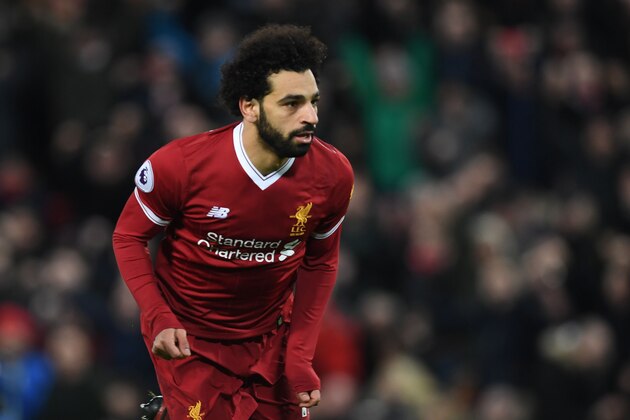 Liverpool's Egyptian midfielder Mohamed Salah celebrates scoring the team's first goal during the English Premier League football match between Liverpool and Leicester at Anfield in Liverpool, north west England on December 30, 2017. / AFP PHOTO / Paul ELLIS / RESTRICTED TO EDITORIAL USE. No use with unauthorized audio, video, data, fixture lists, club/league logos or 'live' services. Online in-match use limited to 75 images, no video emulation. No use in betting, games or single club/league/player publications.  /         (Photo credit should read PAUL ELLIS/AFP/Getty Images)