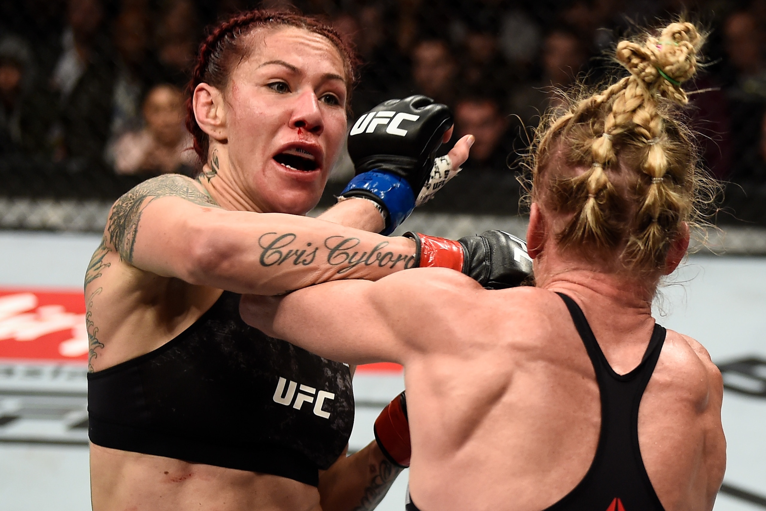 LAS VEGAS, NV - DECEMBER 30:  (L-R) Cris Cyborg of Brazil punches Holly Holm in their women's featherweight bout during the UFC 219 event inside T-Mobile Arena on December 30, 2017 in Las Vegas, Nevada. (Photo by Jeff Bottari/Zuffa LLC/Zuffa LLC via Getty Images)